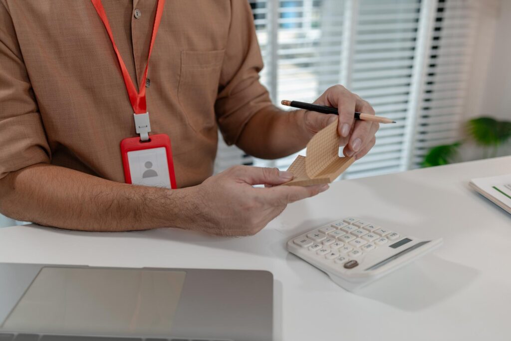 an accountant is working on companys number in the office this employee works in account department the businessman uses calculator to calculate profit of his company in private office