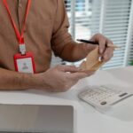 an accountant is working on companys number in the office this employee works in account department the businessman uses calculator to calculate profit of his company in private office