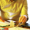 Real Estate Agent Discussing Property Investment with Client Contract Signing and Key Exchange